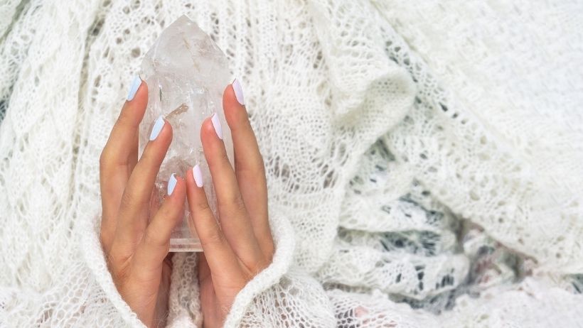 How do Healing Crystals Work for Beginners - holding clear quartz crystal